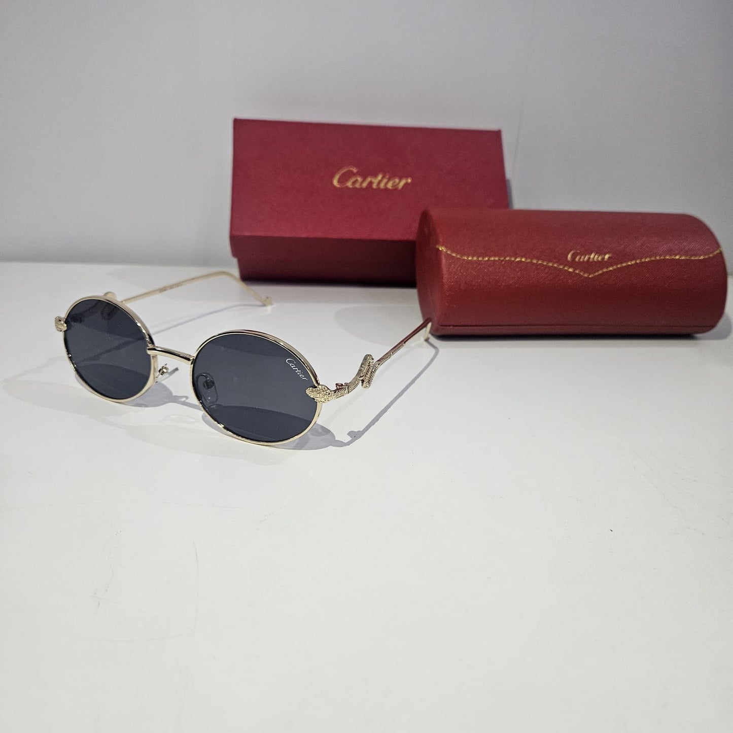 Cartier Elegant Oval Sunglasses with Gold Accents